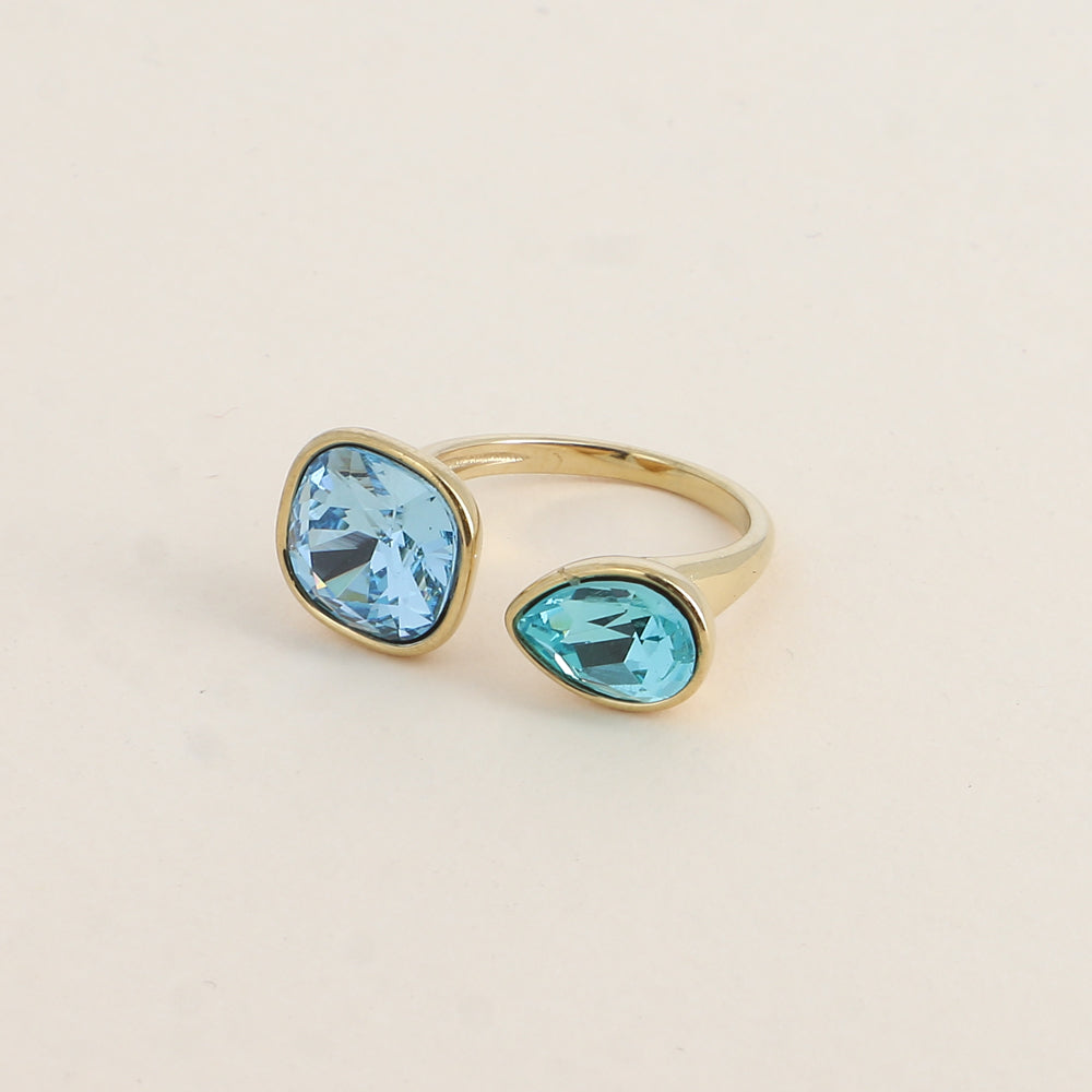 Bague ouverte - Ornée de cristaux de Swarovski® : 10mm été en forme de goutte - Hauteur de la bague: 2 mm - Dimensions des pierres carrée et goutte : 10x10 mm / 7x10 mm - Aquamarine