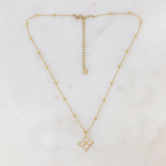 Collier doré composé de petites boules et d'un pendentif embelli de strass blancs 38+7 cm