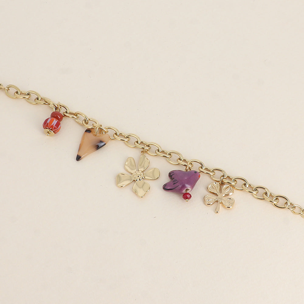 Bracelet - perles et oiseau en céramique, trèfle, cœur en résine et fleur (17+3 cm)