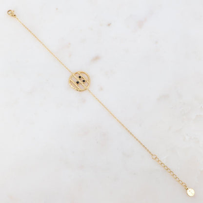 Bracelet avec une pièce ronde et 3 strass