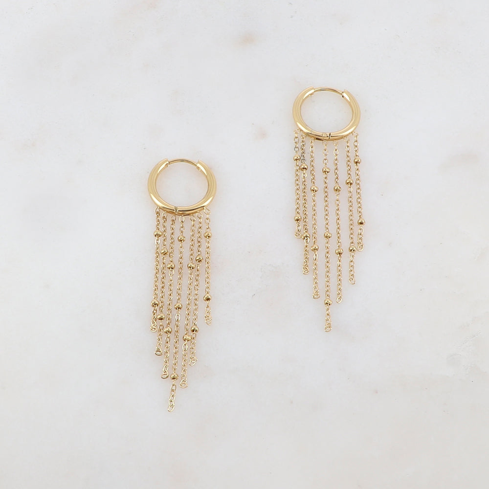 Créoles avec 7 chaînes tombantes et petites boules Diamètre créoles : 1,5 cm. Dimensions chaînes : 4,5 cm, 4 cm, 3,5 cm, 3 cm.