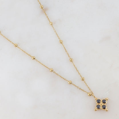 Collier doré composé de petites boules et d'un pendentif embelli de strass noirs 38+7 cm
