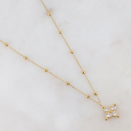 Collier doré composé de petites boules et d'un pendentif embelli de strass blancs 38+7 cm