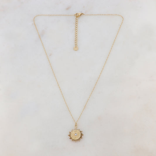 Collier doré composé d'un pendentif ajouré de façon soleil avec œil et strass blanc 41+5 cm