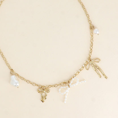 Collier - noeuds papillons avec des pièces en résine blanche 41,5+5 cm