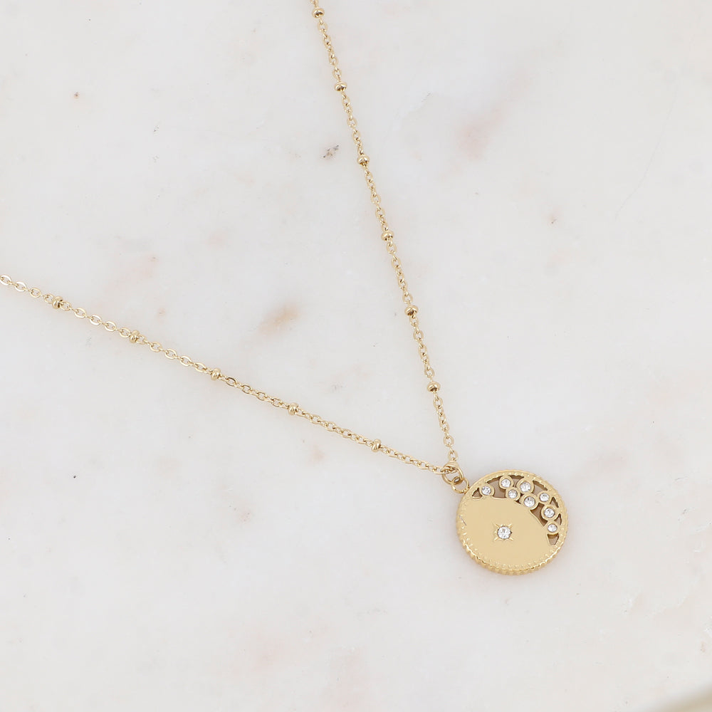 Collier doré avec pendentif rond ajouré avec un motif étoile et embelli de strass 40+5 cm