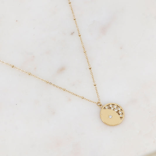 Collier doré avec pendentif rond ajouré avec un motif étoile et embelli de strass 40+5 cm