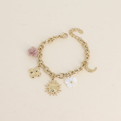 Bracelet - fleur en résine, fleur nacrée, soleil, lune et trèfle (17+3 cm)