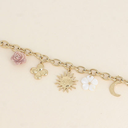 Bracelet - fleur en résine, fleur nacrée, soleil, lune et trèfle (17+3 cm)