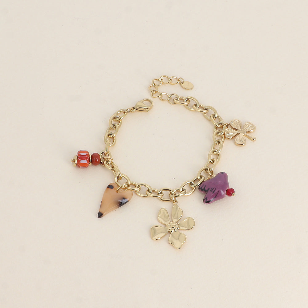 Bracelet - perles et oiseau en céramique, trèfle, cœur en résine et fleur (17+3 cm)