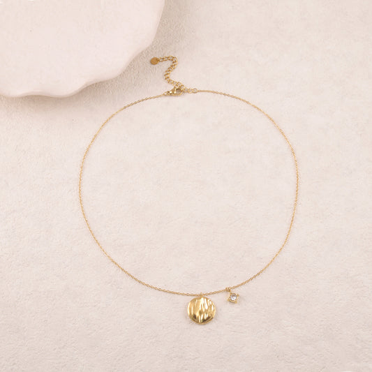 Collier doré avec un strass et deux anneaux texturés au bout de chaînes tombantes 40+5 cm