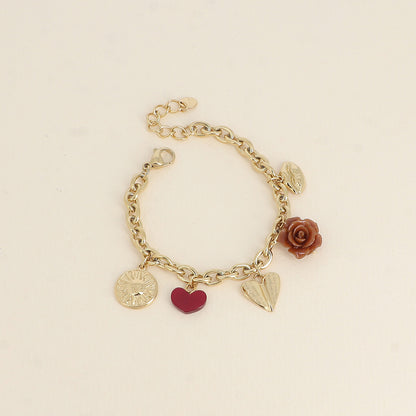 Bracelet - breloques diverses (soleil, cœur en résine, cœur incurvé, rose en résine, bouche) (17+3 cm)