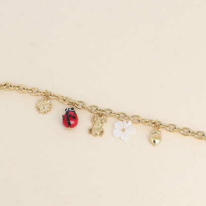 Bracelet - pendentifs (soleil, coccinelle en céramique émaillée, scarabée, fleur nacrée, cœur) (17+3 cm)