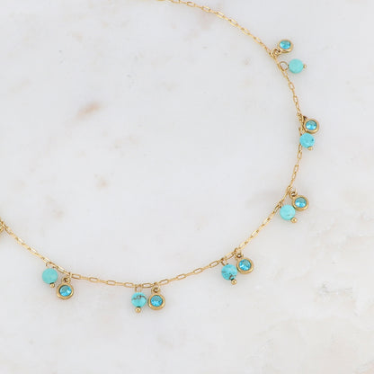 Collier doré embelli de pierres et de strass turquoises 38+5 cm