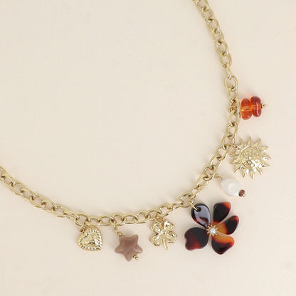 Collier - pendentifs (soleil, perle d'eau douce, trèfle, étoile et fleur en résine, cœur) 40+7 cm