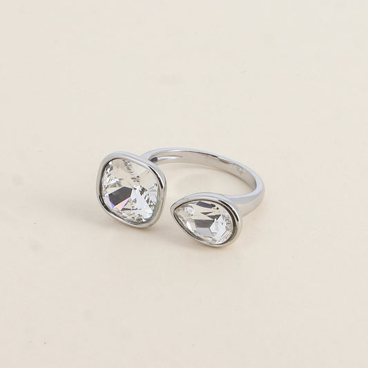 Bague ouverte rhodium - Ornée de cristaux de Swarovski® : 10mm été en forme de goutte - Hauteur de la bague: 2 mm - Dimensions des pierres carrée et goutte : 10x10 mm / 7x10 mm - Crystal