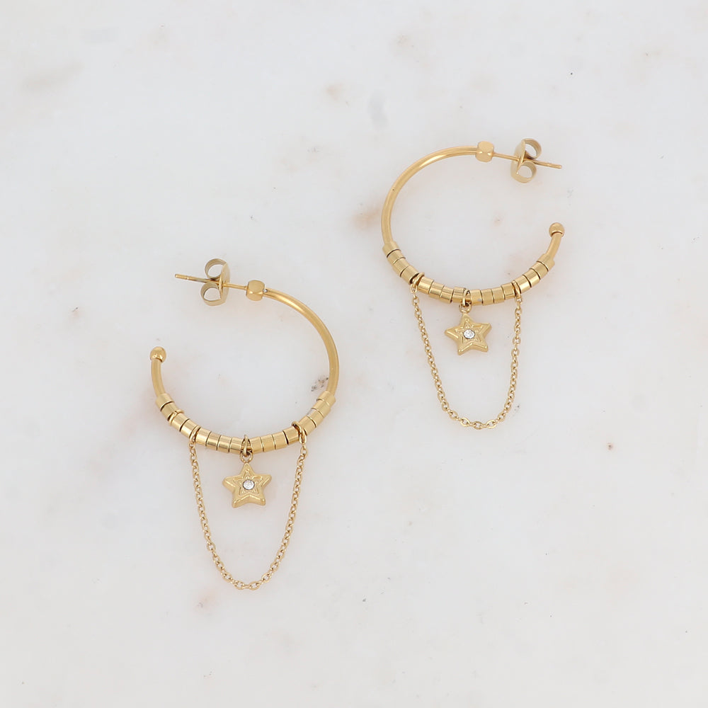 Créoles à puce avec chaînes tombantes, petites rondelles et pampille étoile strassée 2,8 x 6 cm.
